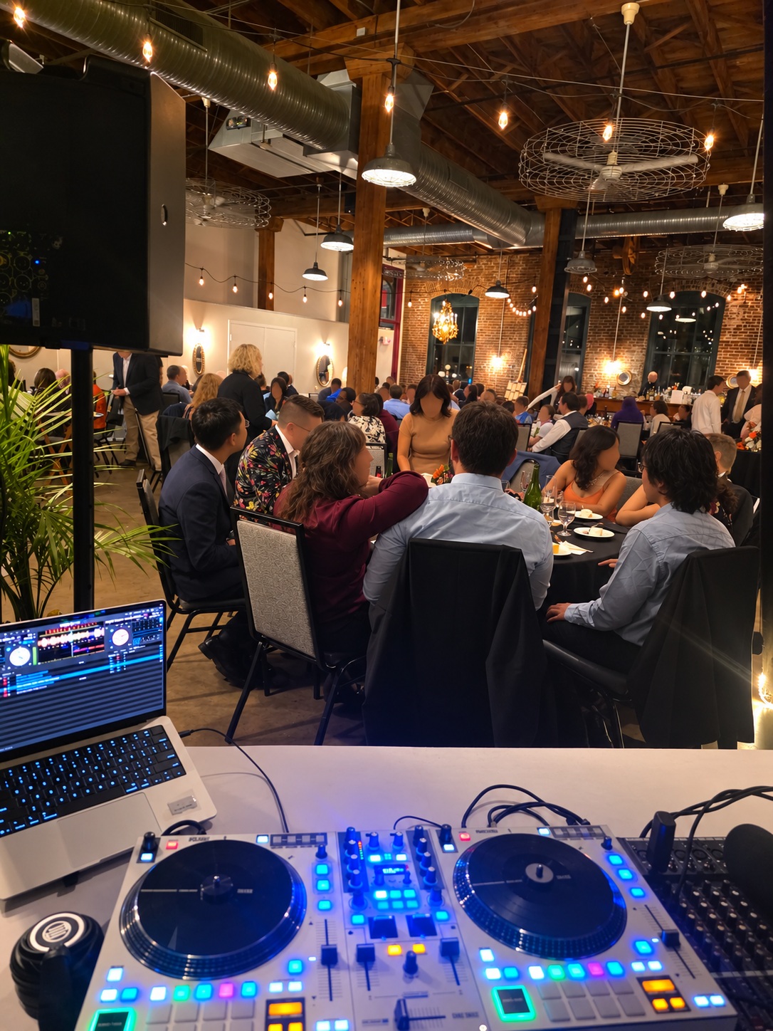 Sir Uso Live DJ booth running a banquet event in an industrial brick venue